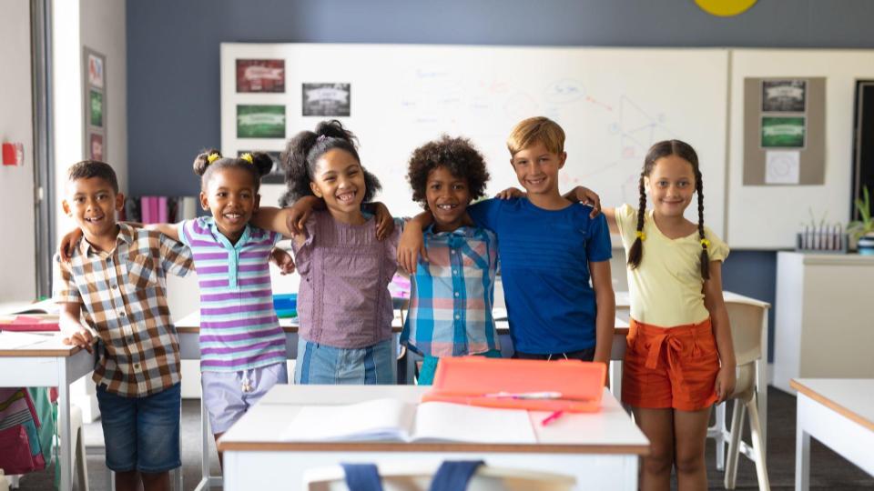 Happy elementary classroom with students smiling