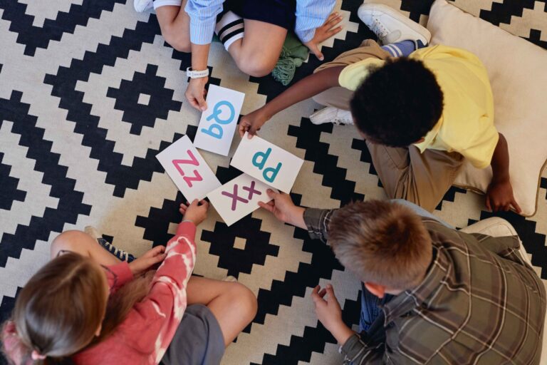 Kids laying alphabet cards on the floor