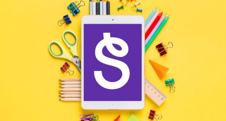 Seesaw S on a device over school supplies